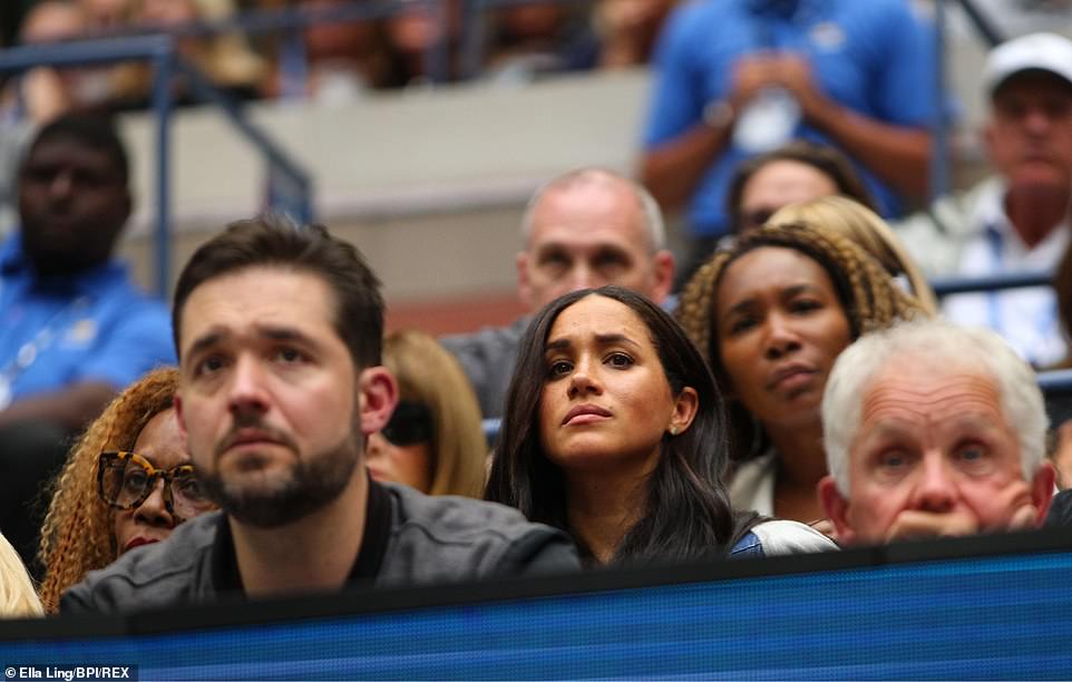 Meghan peers down to the blue-coloured hard court below at the Arthur Ashe Stadium during Williams ' US Open defeat