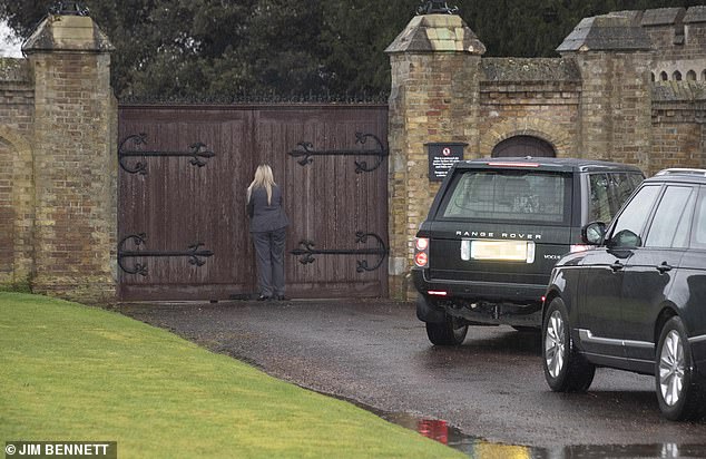 Pictured: The female bodyguard attempts to pull open the gate, but to no avail