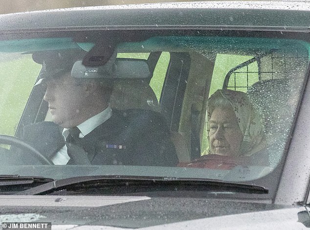 Pictured: The Queen waiting in the Range Rover for the gate to Windsor Castle to open